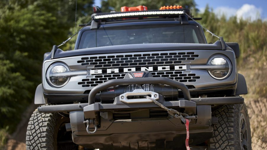 A head-on view of a black 2021 Ford Bronco with a aftermarket off-road bumper and winch.
