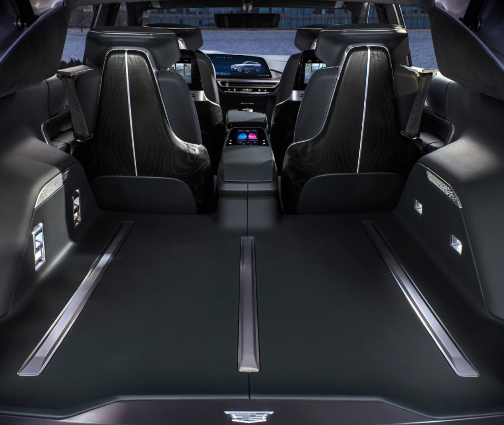 The interior of the Cadillac Lyriq electric SUV is shown from the rear perspective.