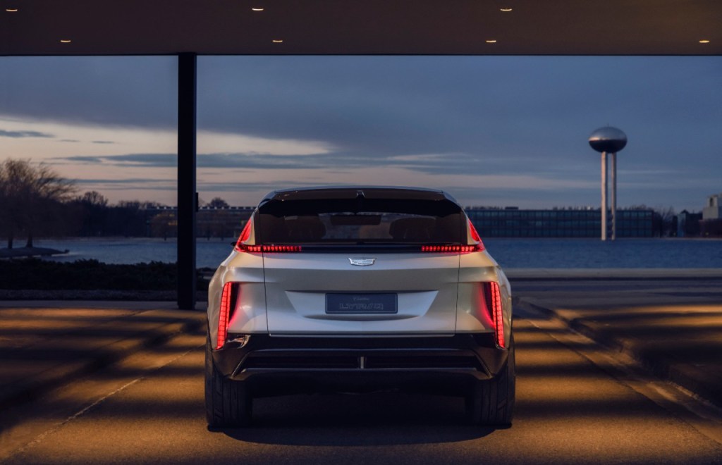 The rear of the electric Cadillac Lyriq bounces off the light at dusk.