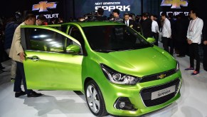 Visitors look at Chevrolet's next generation Spark car during a press preview of the Seoul Motor Show