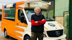 Edd China, former co-host of the Wheeler Dealer television show stands before his EV ice cream truck.