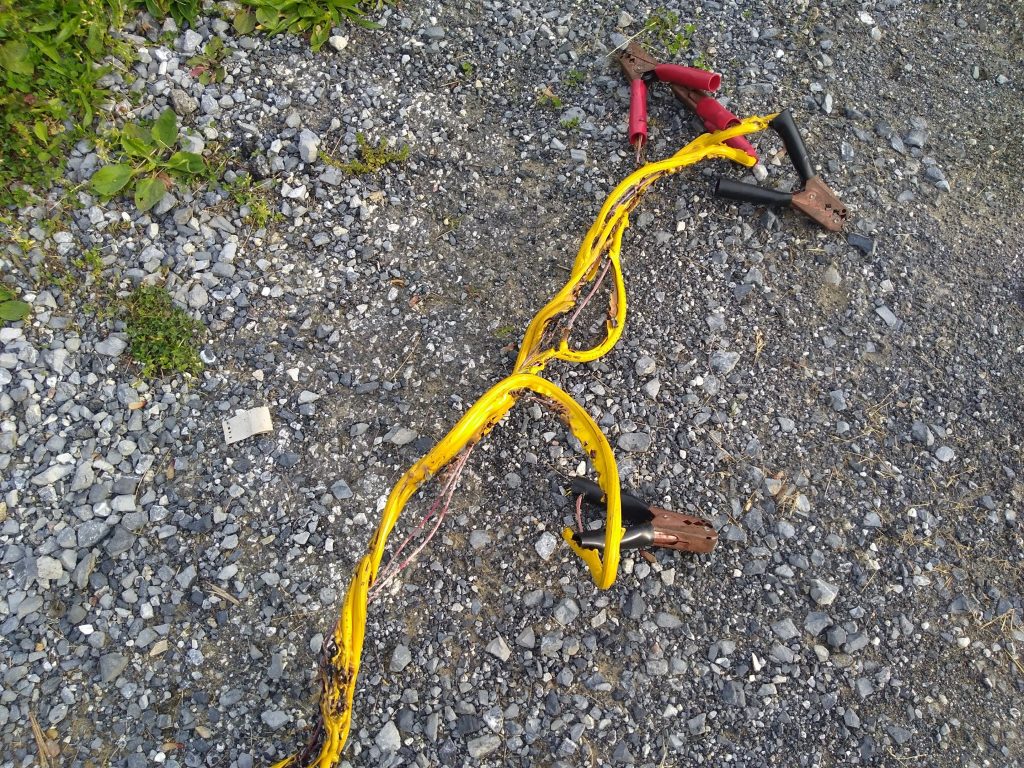 Jumper cables that were attached incorrectly on a car battery started to melt and expose the wire within.