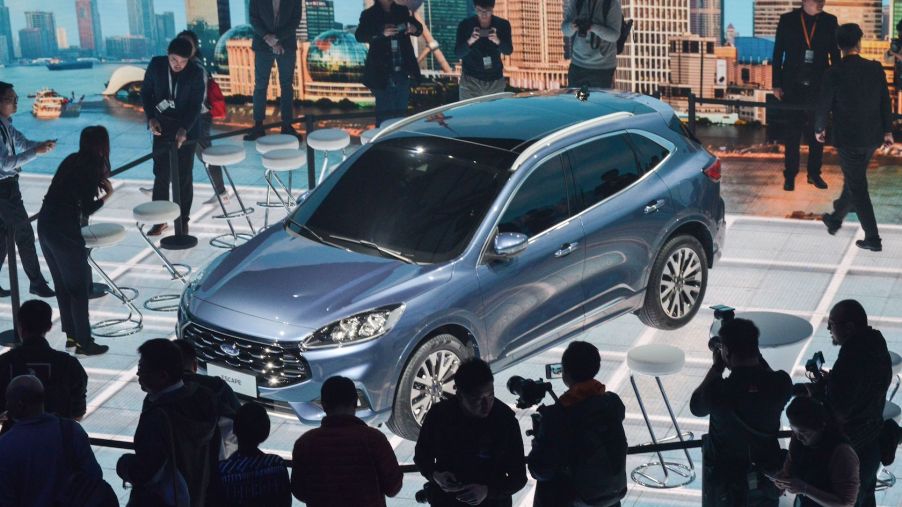 This photo taken on April 3, 2019 shows photographers taking photos of a new Ford Escape car during a press conference in Shanghai