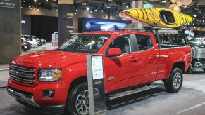 A red GMC Canyon on display at an auto show