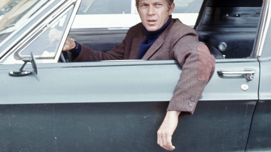 American actor Steve McQueen (1930 - 1980) (as Frank Bullitt) hangs his arm out the driverside window of a car in a scene from 'Bullitt' (directed by Peter Yates), California, 1968.