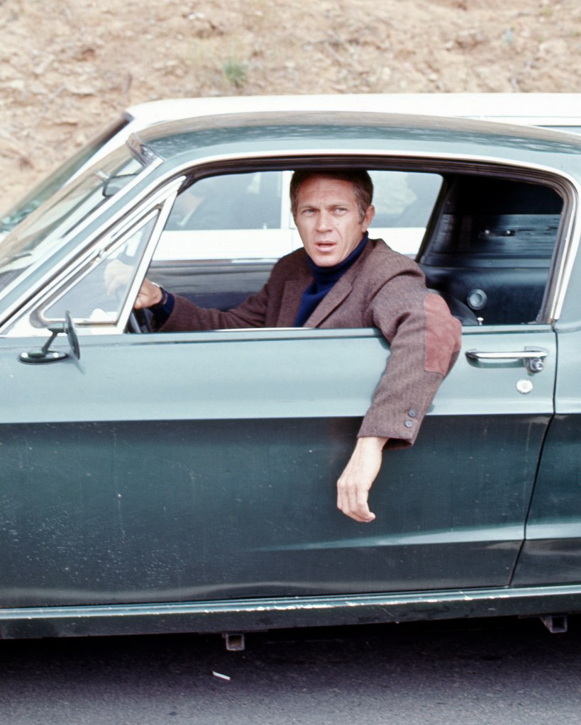 American actor Steve McQueen (1930 - 1980) (as Frank Bullitt) hangs his arm out the driverside window of a car in a scene from 'Bullitt' (directed by Peter Yates), California, 1968.