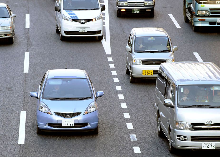 A Honda 'Fit' (L) is driven down a road in Tokyo on February 4, 2011. In January the Honda 'Fit' replaced Toyota's popular hybrid 'Prius' model as Japan's top selling car, a title that the Toyota model had held since May 2009, the Japan Automobile Dealers' Association said in a monthly report. AFP PHOTO / TOSHIFUMI KITAMURA (Photo credit should read TOSHIFUMI KITAMURA/AFP via Getty Images)