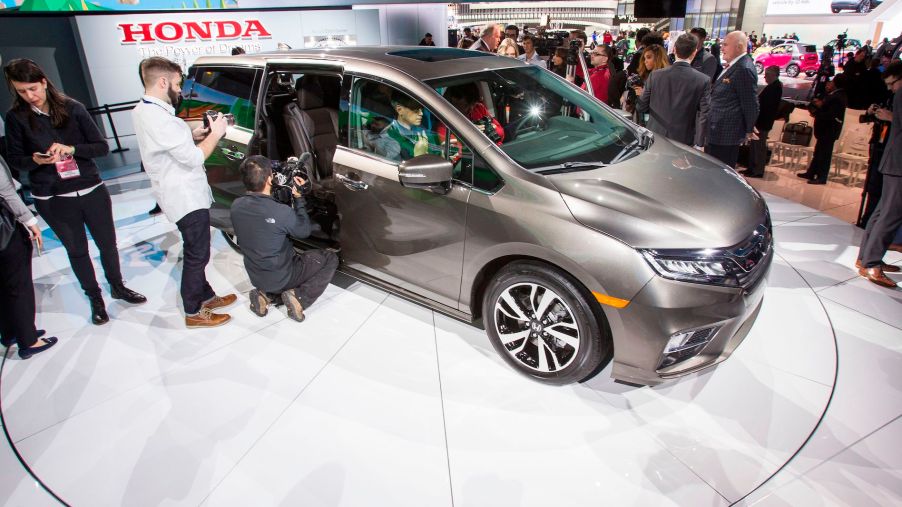 Journalists take a look at the 2018 Honda Odyssey during a press conference at the 2017 North American International Auto Show