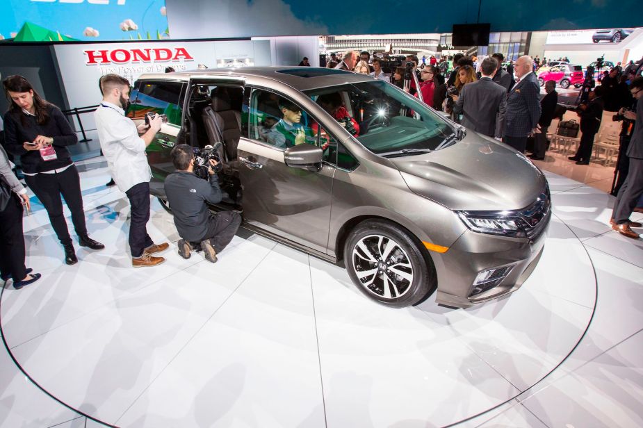 Journalists take a look at the 2018 Honda Odyssey during a press conference at the 2017 North American International Auto Show