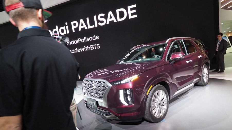 People checking out a new Hyundai Palisade at an auto show