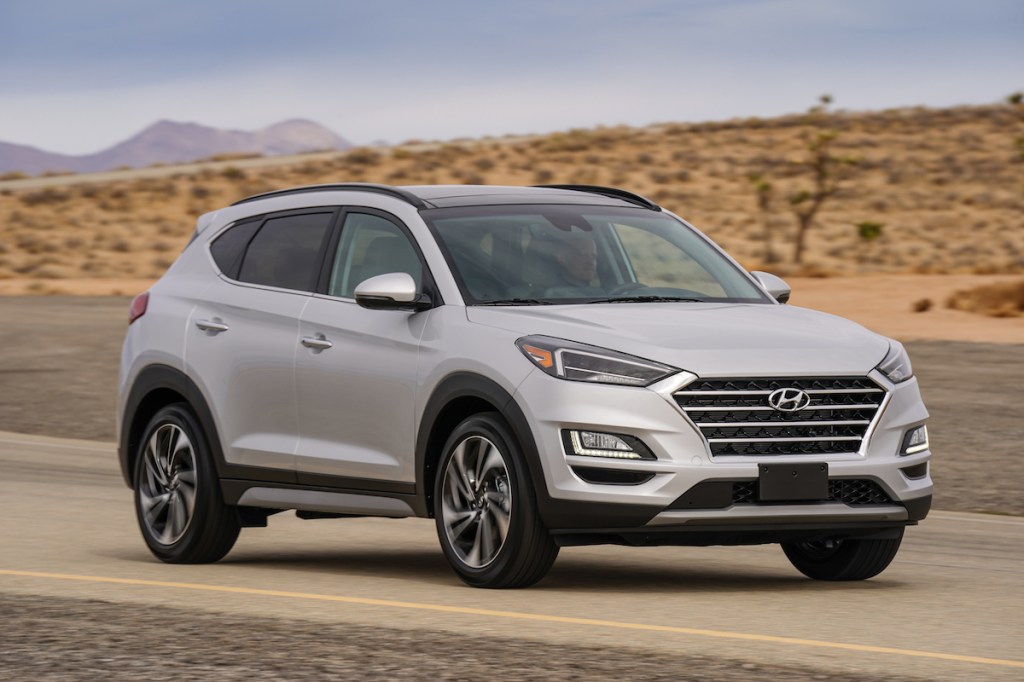 A silver model of the Korean brand's Tuscon crossover SUV in the desert competes with other made by a Japanese car company