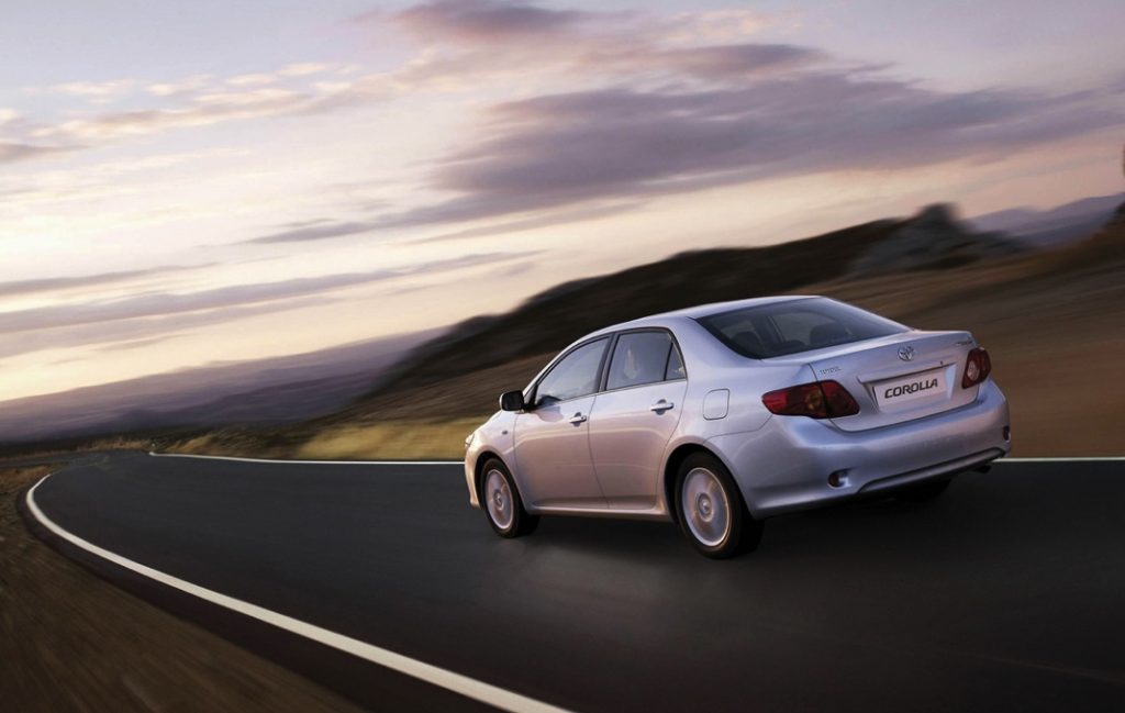 one of the best cars, Toyota Corolla 2007 model year rear view driving in the country