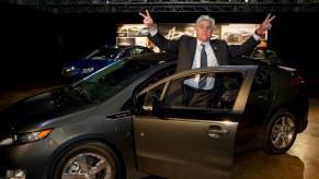 Jay Leno posing with a car