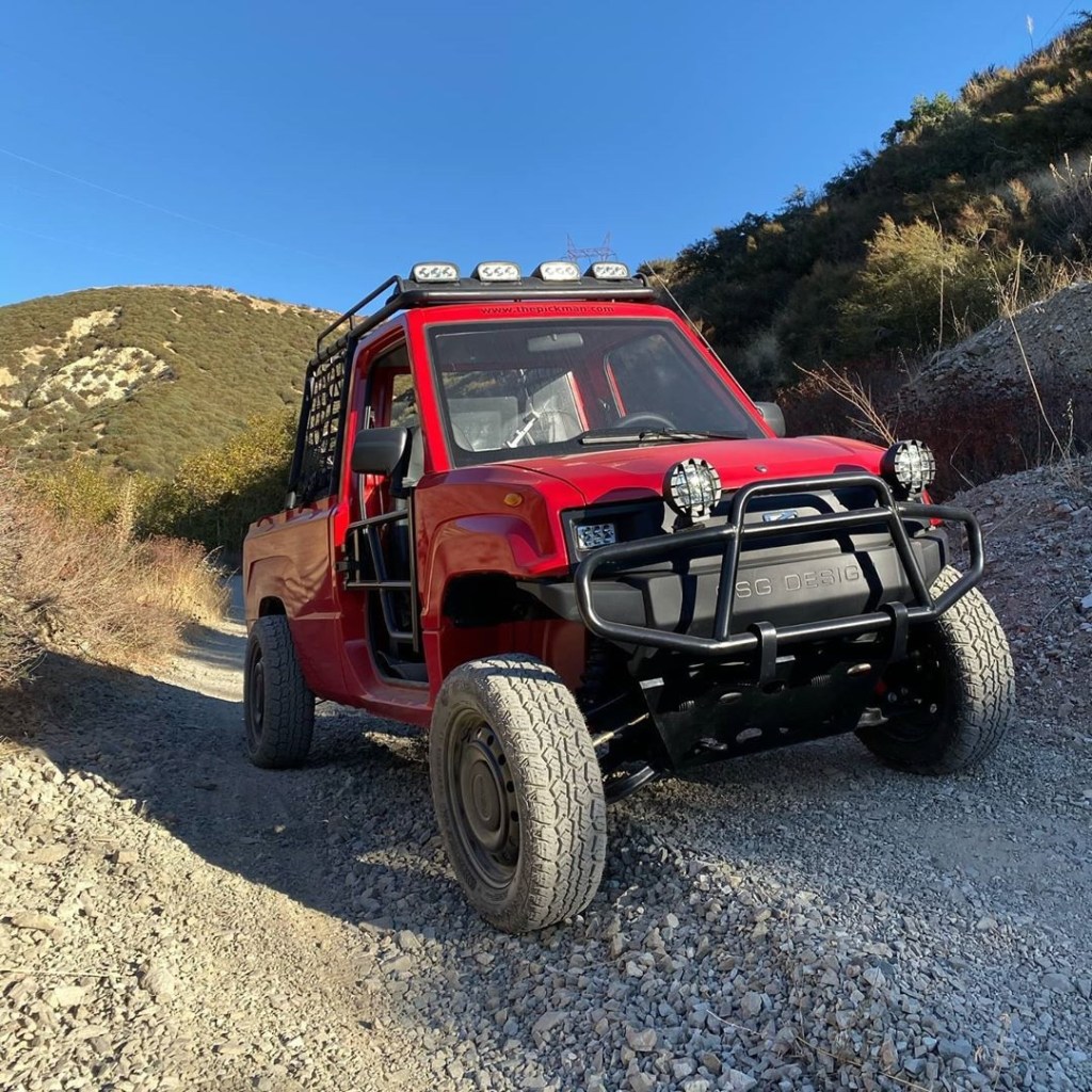 A red Kaiyun Motors Pickman XR on a rocky mountain trail