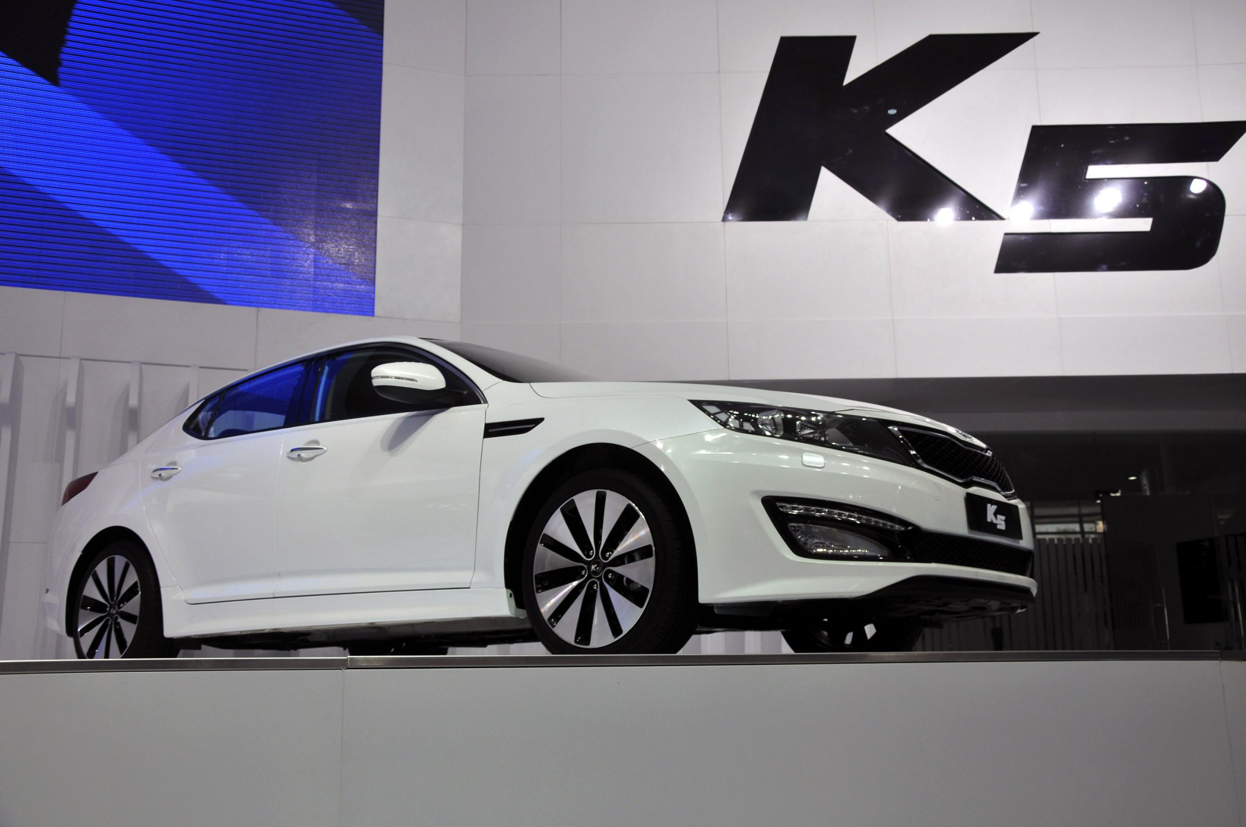 A Kia K5 on display at an auto show