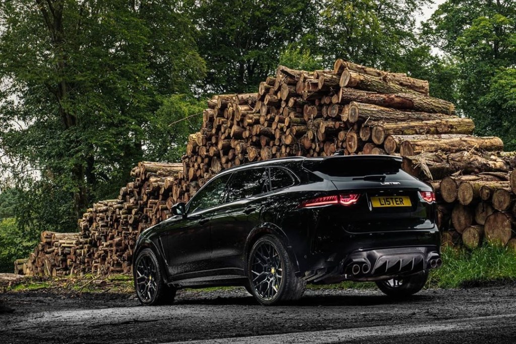 The rear view of a black Lister Stealth in front of a pile of cut logs