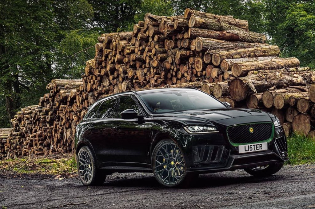 A black Lister Stealth in front of a pile of cut logs