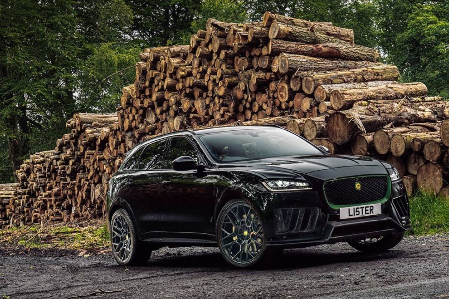 A black Lister Stealth in front of a pile of cut logs