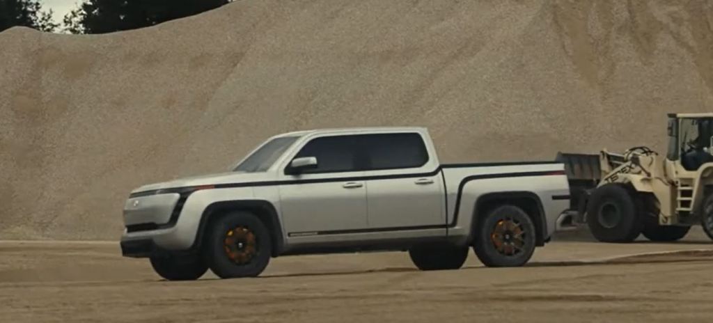 A silver 2021 Lordstown Motors Endurance electric pickup sits in a gravel pit.