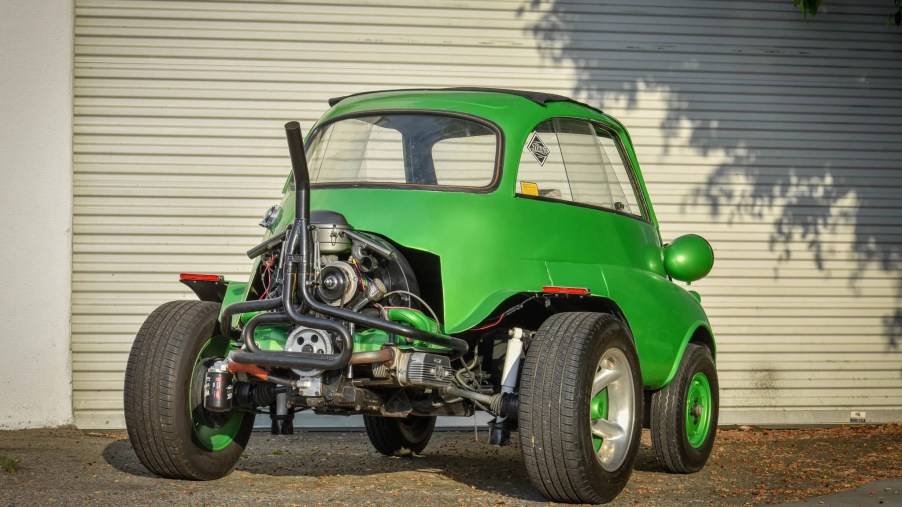 The rear view of a green modified 1957 BMW Isetta, showing the Volkswagen Beetle engine and subframe