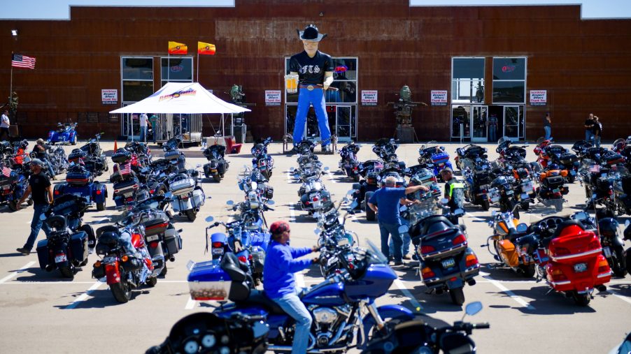 A motorcycle rider looks for a parking spot outside the Full Throttle Saloon during the 80th Annual Sturgis Rally