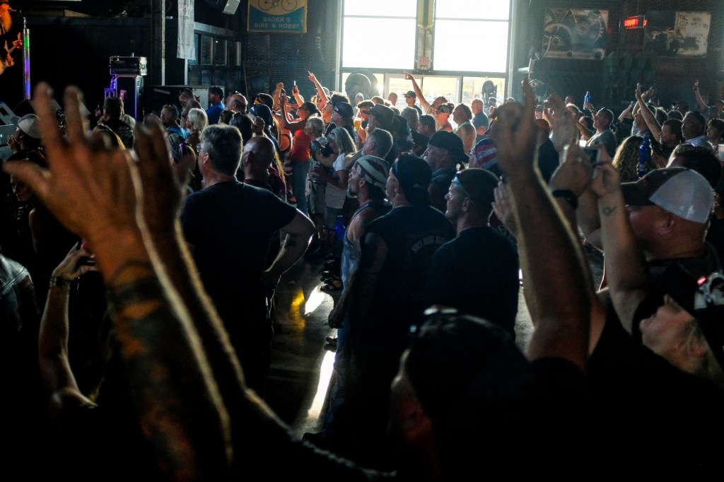People cheering at a concert during the 80th Annual Sturgis Motorcycle Rally