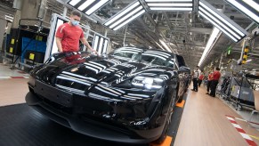 An employee of Porsche AG wears a mouthguard in the production of the battery electric driven sports car Porsche Taycan