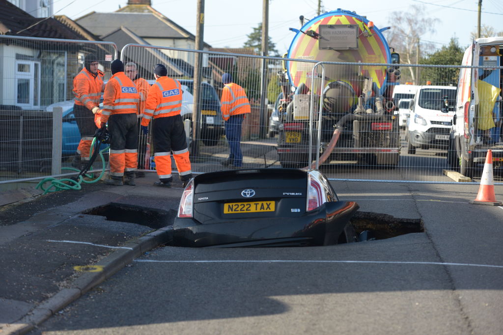 A Toyota car sits in a sinkhole which appeared overnight in Hatch Road, Brentwood, in the aftermath of Storm Ciara, which hit the country on Sunday. PA Photo. Picture date: Monday February 10, 2020. See PA story WEATHER Storm. Photo credit should read: Nick Ansell/PA Wire (Photo by Nick Ansell/PA Images via Getty Images)