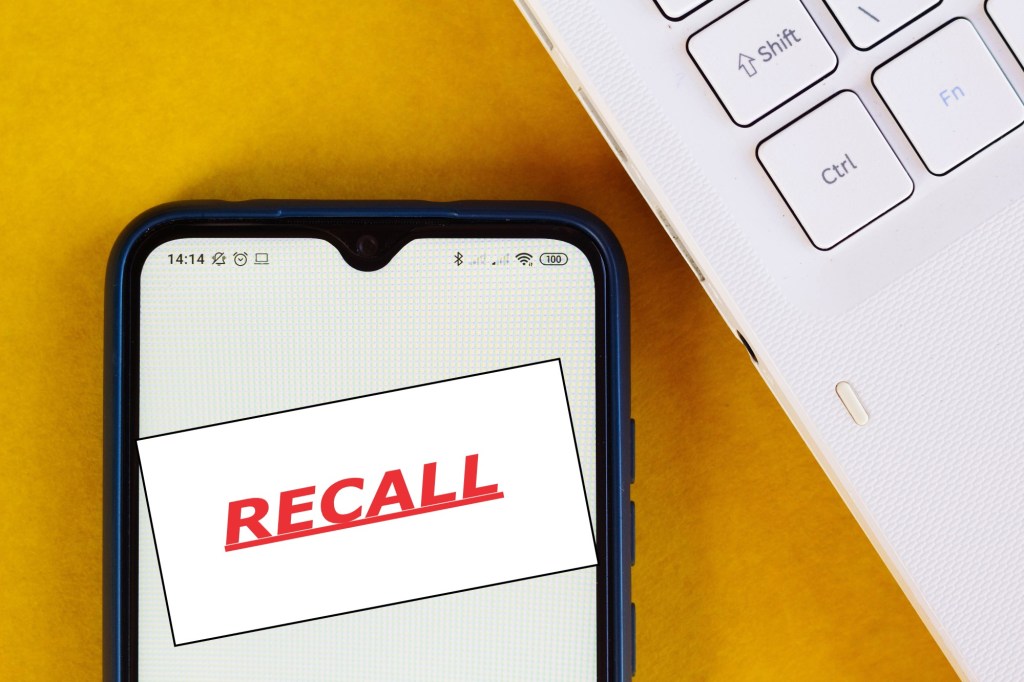 The word, RECALL, is seen displayed on a smartphone.