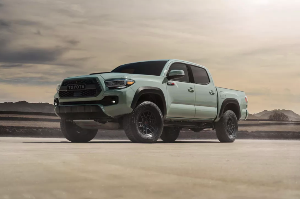 A 2021 Toyota TRD Pro Tacoma parked on sand is smaller than larger off-road options like the Ram 1500 TRX