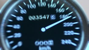 A speedometer shows the needle near 200 kph.