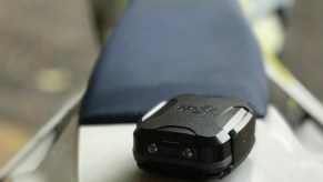 A black Spot Trace motorcycle tracker on a Husqvarna enduro bike