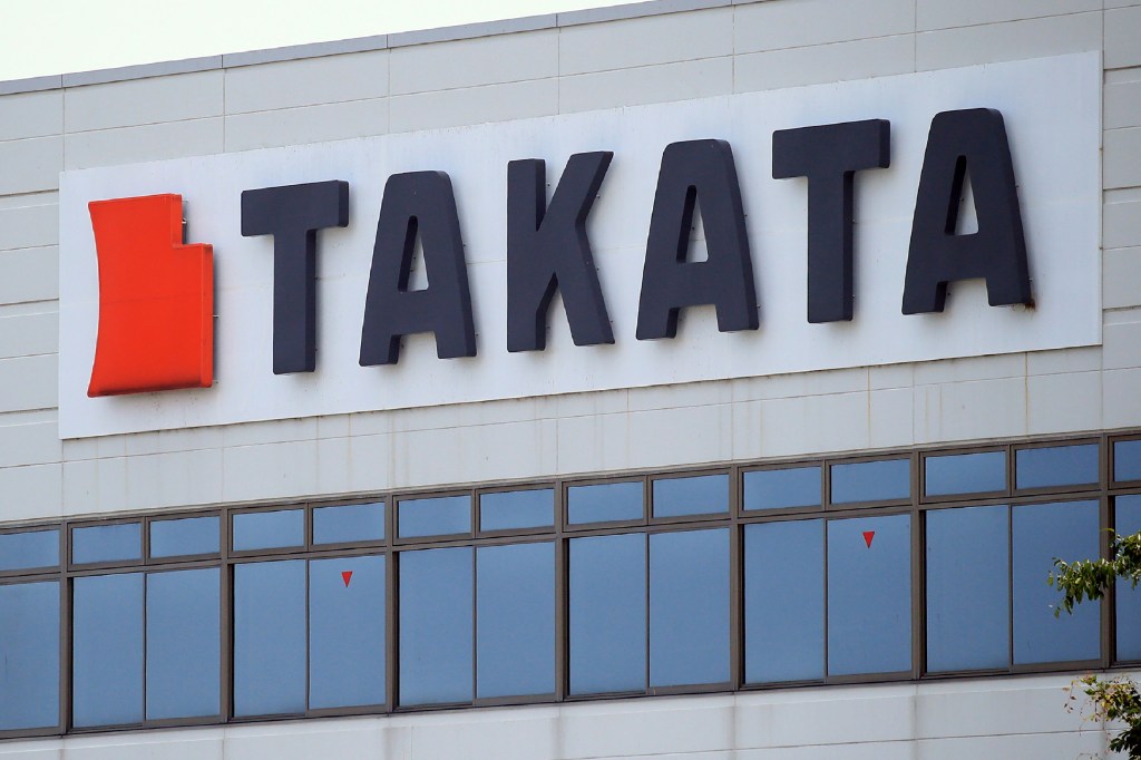 The red and black Takata logo on the side of a building in Japan
