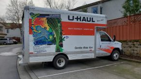 A U-Haul box truck is seen parked in a residential neighborhood.