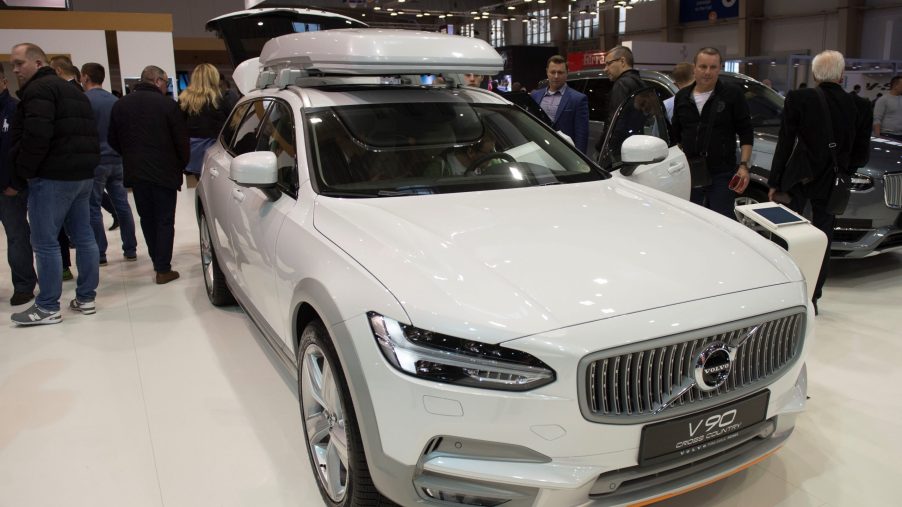 A white Volvo V90 on display at an auto show