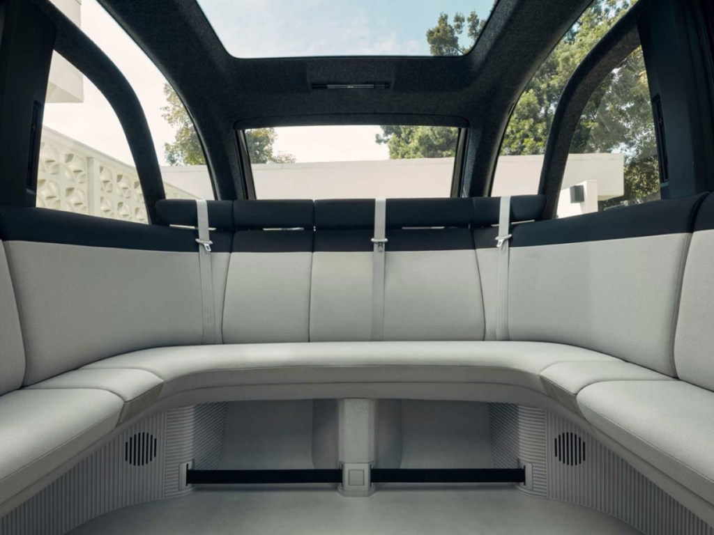 The rear of the Canoo electric van shows a couch-like seating area.