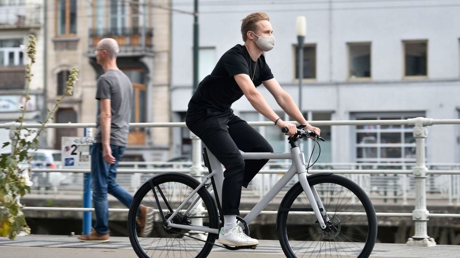 A man rides down the street on an e-bike