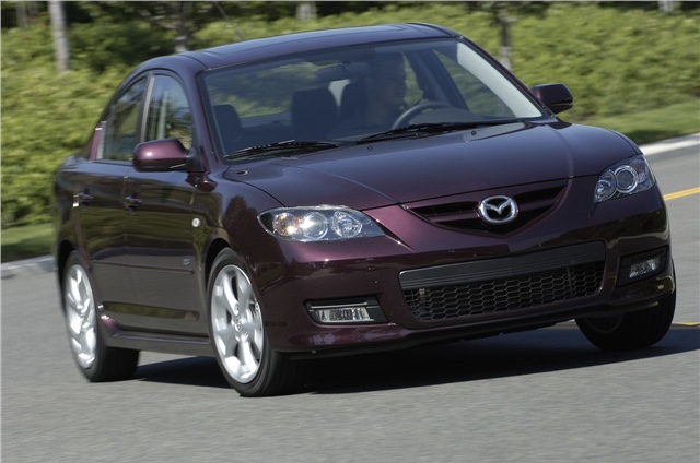 2008 Mazda3 in a purple color driving on the road