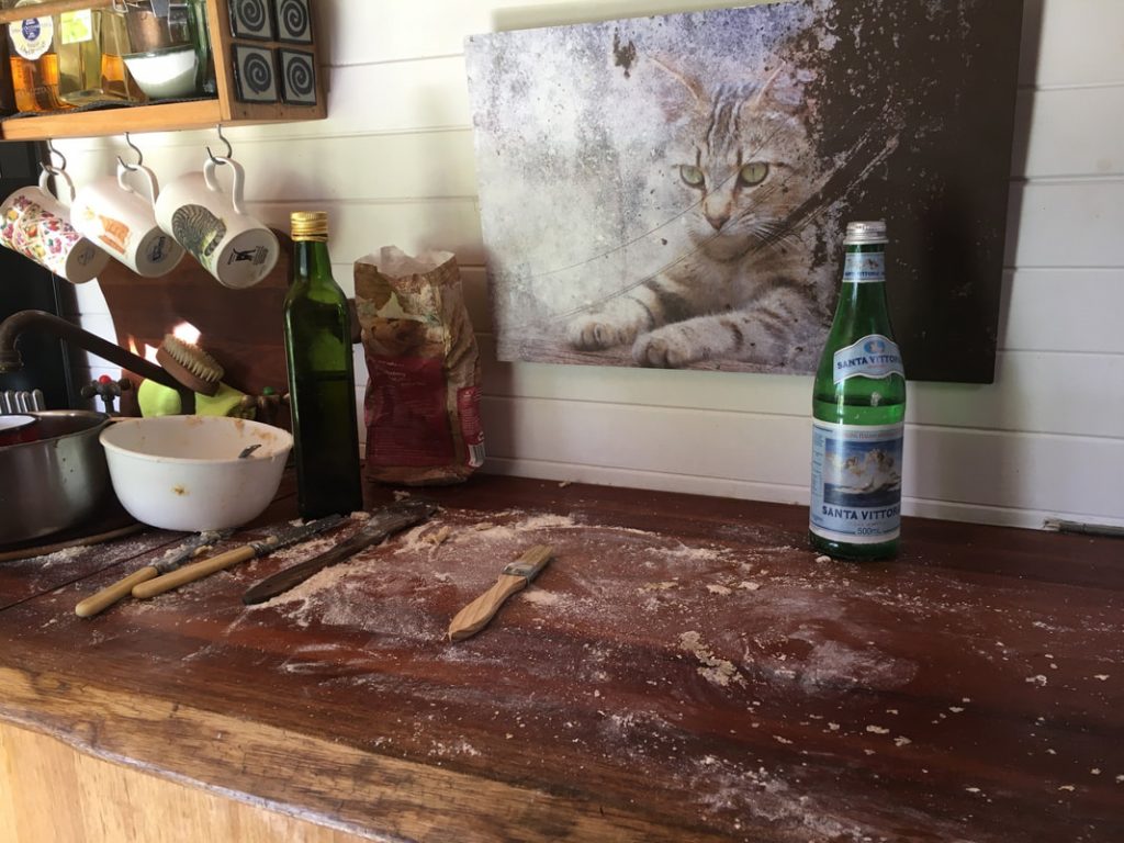 a rustic wooden countertop covered with sprinkles of flour