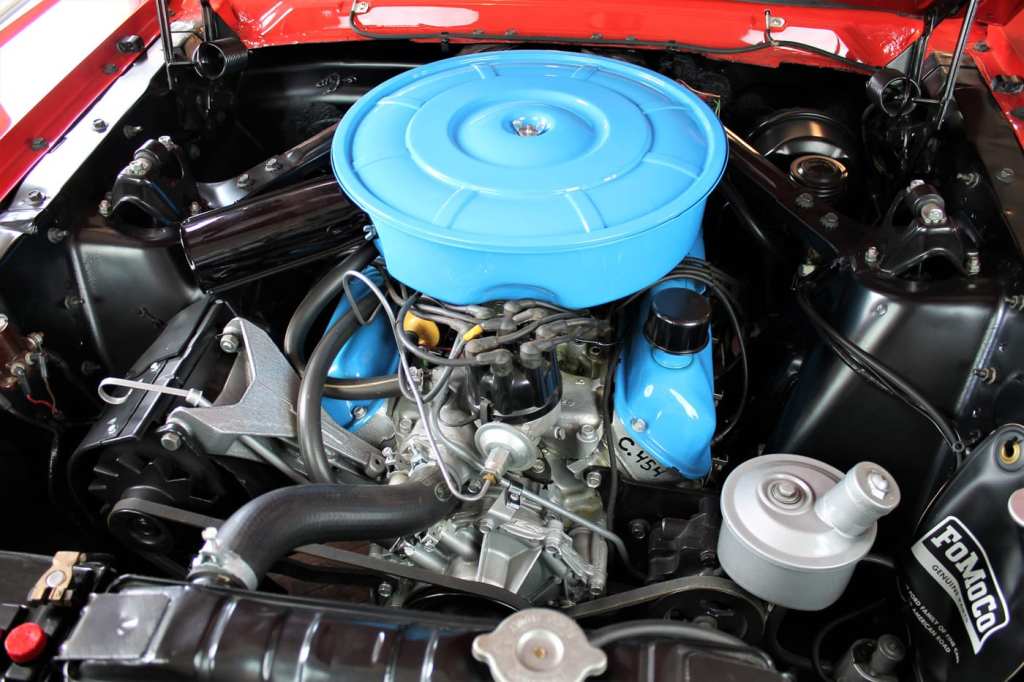 The original detailed engine is viewed from a classic Ford Mustang