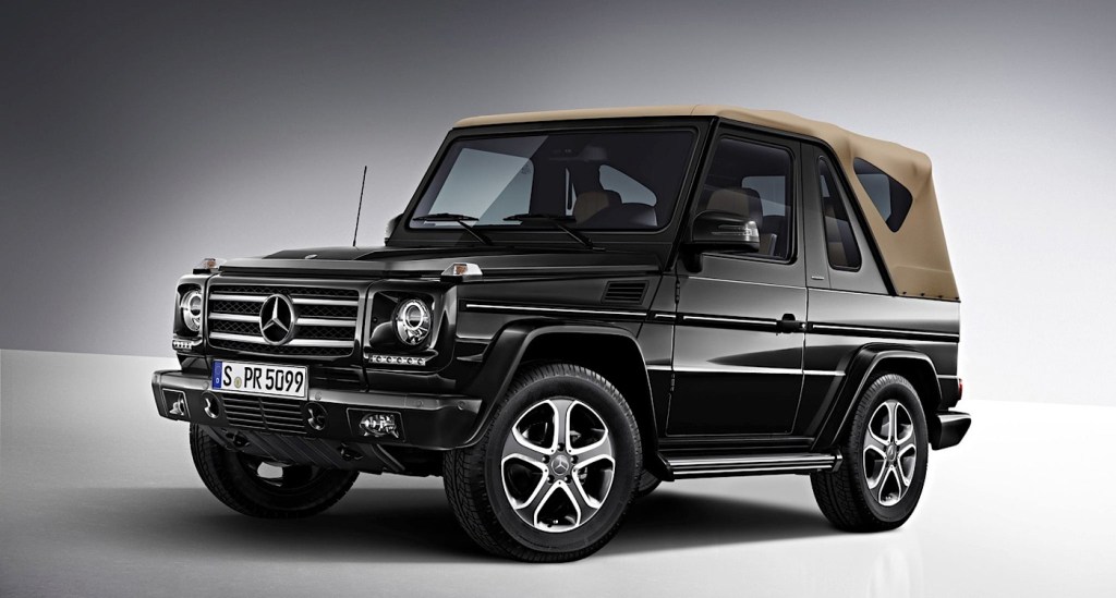 a black cabriolet g-wagon with a tan convertible top, press phot against a gray backdrop