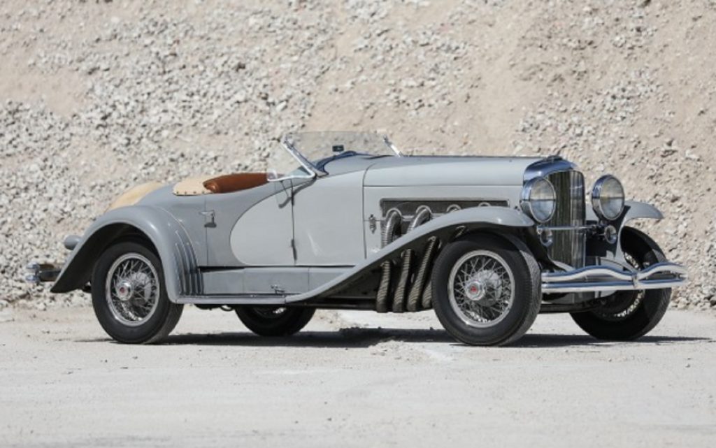 A gray 1935 Duesenberg Model SSJ in a quarry