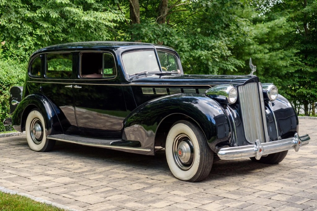 A dark-blue 1938 Packard Super Eight Touring Sedan