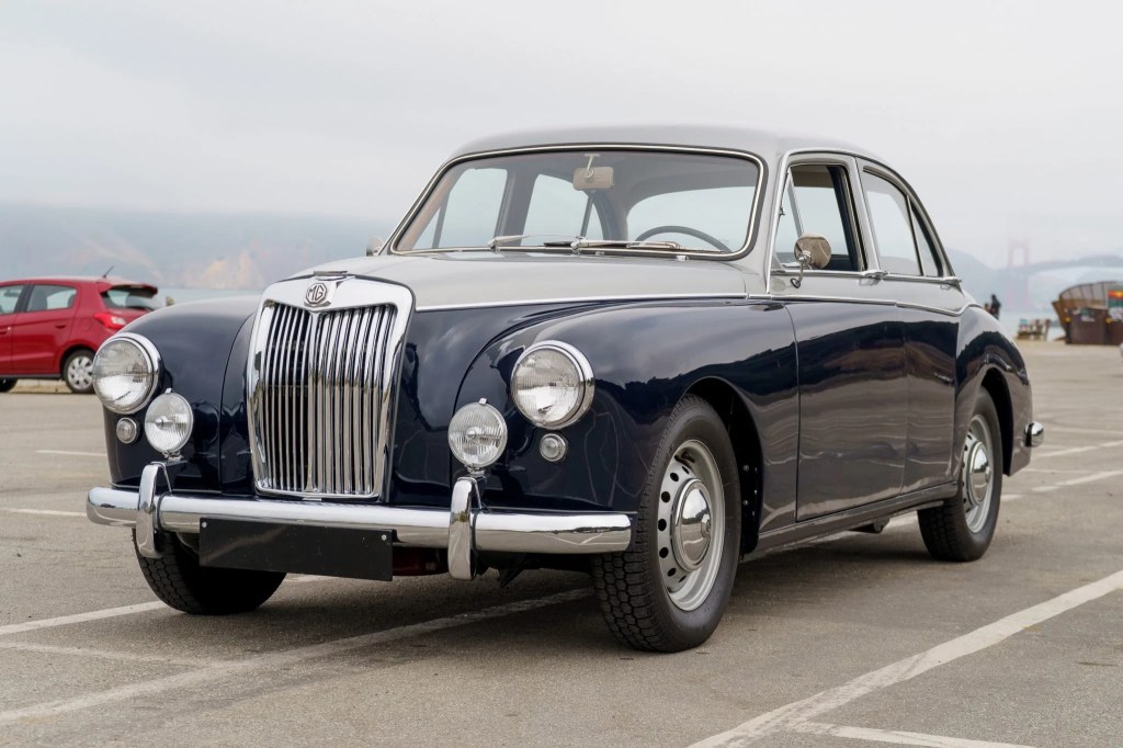 A blue-and-silver 1958 MG Magnette ZB Varitone by the sea