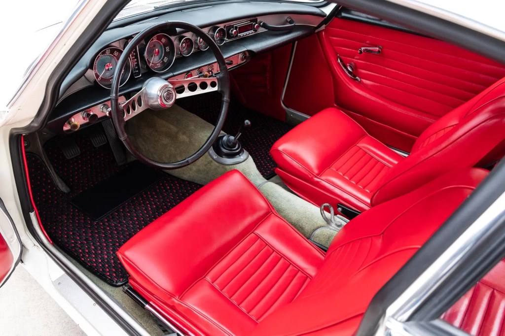 The red-leather interior of a white 1964 Volvo P1800S