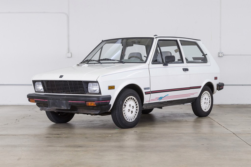 A white, small compact hatchback - the 1989 Yugo