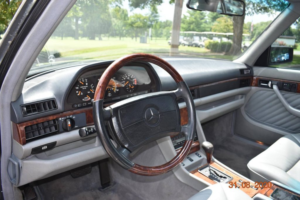 The gray-leather-upholstered and wood-trimmed front interior of the 1991 W126 Mercedes-Benz 560SEL