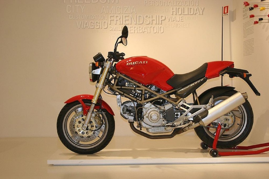 A red 1993 Ducati Monster M900 on a rear-wheel stand in the Ducati museum