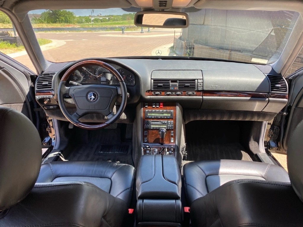 The black-leather-upholstered 1998 Mercedes-Benz W140 S600's interior