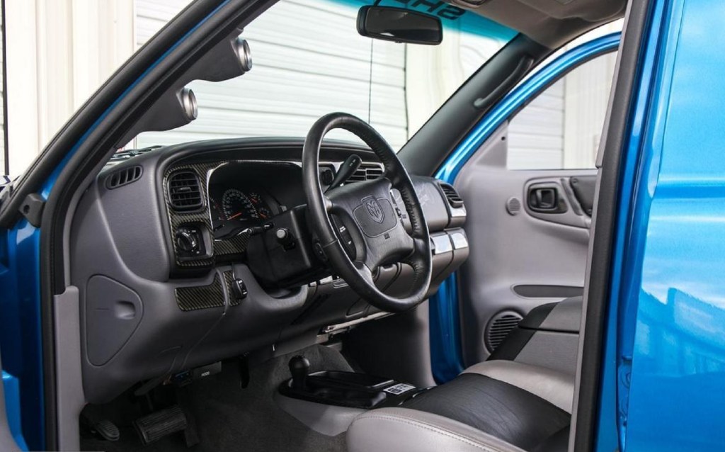 The gray-and-black front interior of a blue 1999 Dodge Durango Shelby SP-360